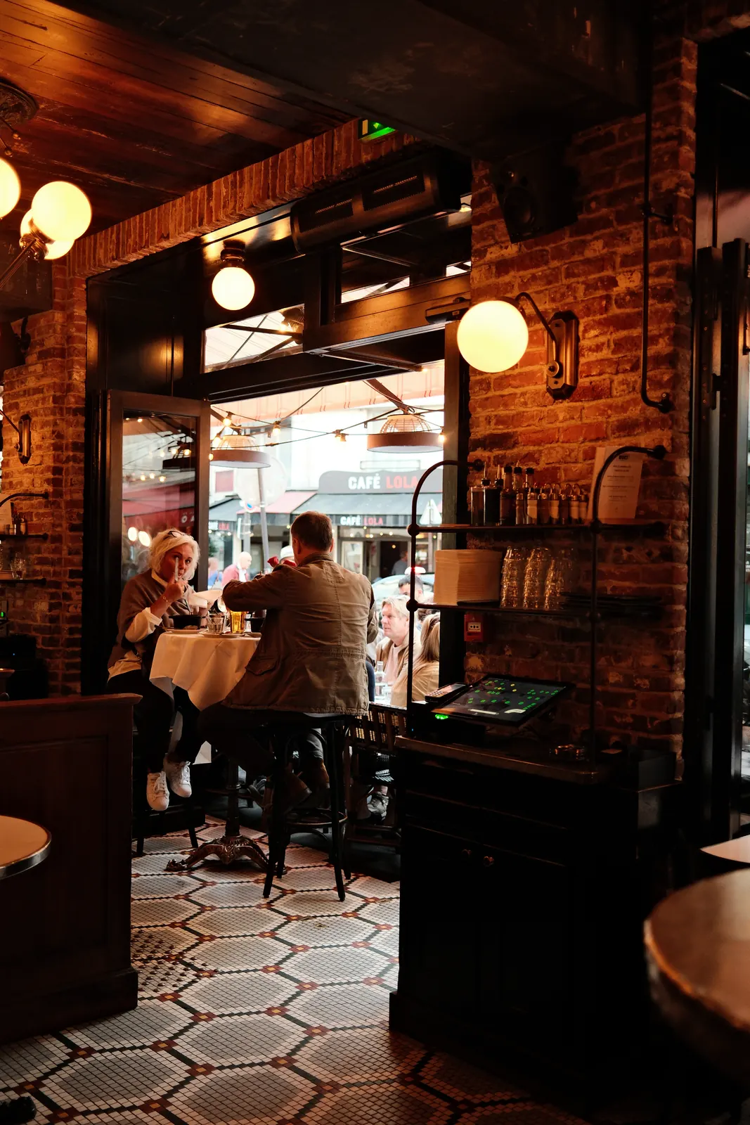The dining room: brick, mosaic and a view of the terrace