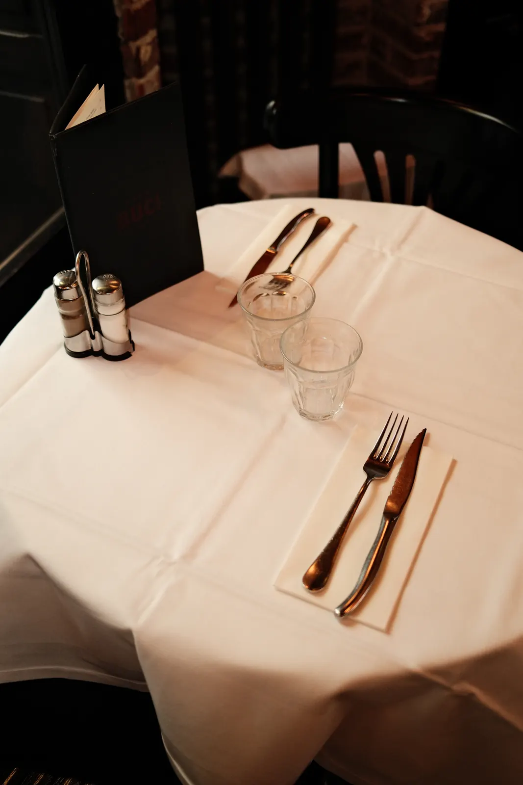 White tablecloth, cutlery and menu